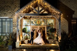 couple dance outside the doors to the Coach House, at Manor House Lindley