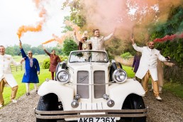a Baraat in a Beauford car with smoke bombs and smiles