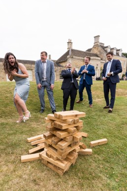 a giant Jenga tower collapses at a wedding