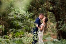 newlyweds kiss in the woods