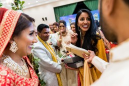 groom buys back his shoes at a hindu wedding