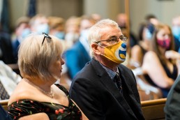 man wears a Children's Hospital Charity mask to a wedding