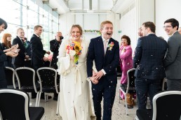 bride and groom exit their wedding at Millennium Gallery in Sheffield