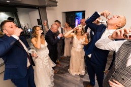 7 people slamming jagerbombs at a wedding including the bride and groom