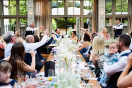 long tables of family and friends toast the happy couple at Hampton Manor