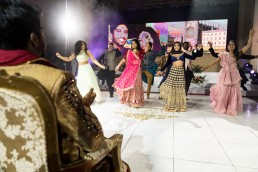 bride and her friends do a dance for the groom at a Tamil wedding