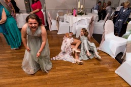 wedding guests lay on the floor after falling over dancing