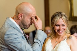 groom cries and bride laughs at their wedding