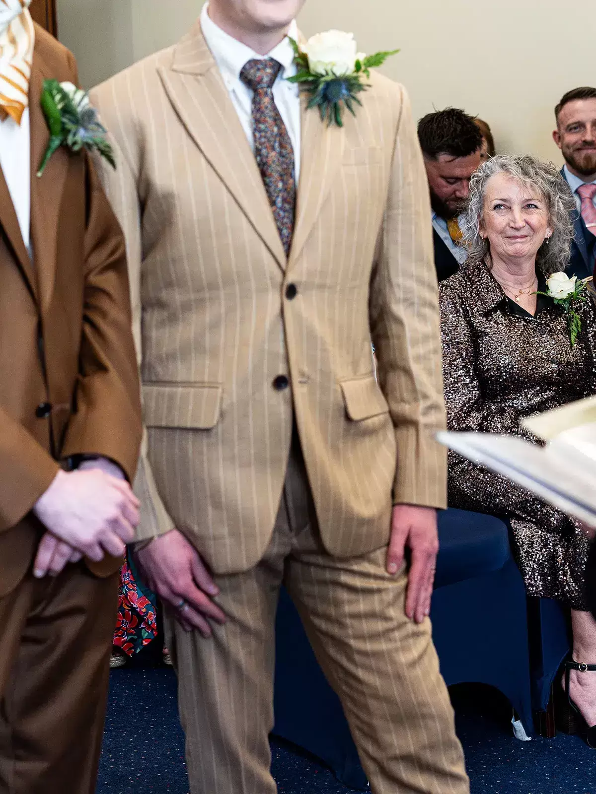 Mother of the groom smiling with pride during wedding ceremony in the Hallam Room at Sheffield Town Hall