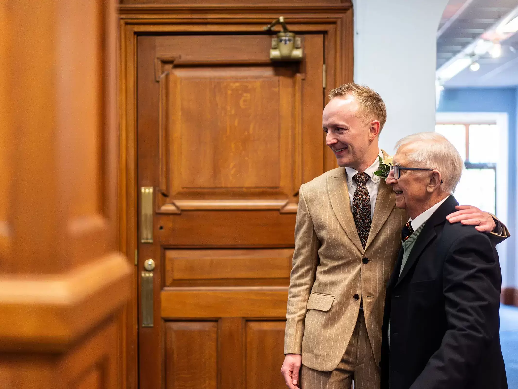Groom waiting outside the Hallam Room at Sheffield Town Hall with his grandfather before the wedding ceremony