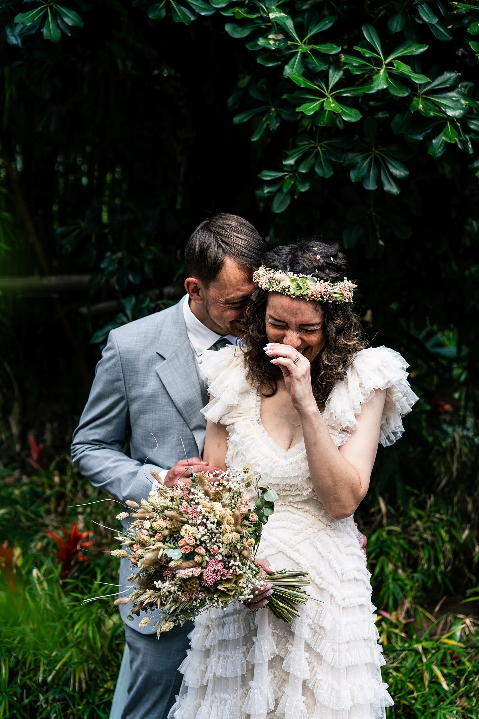 Bride and groom laughing together during wedding portraits in the Sheffield Winter Gardens